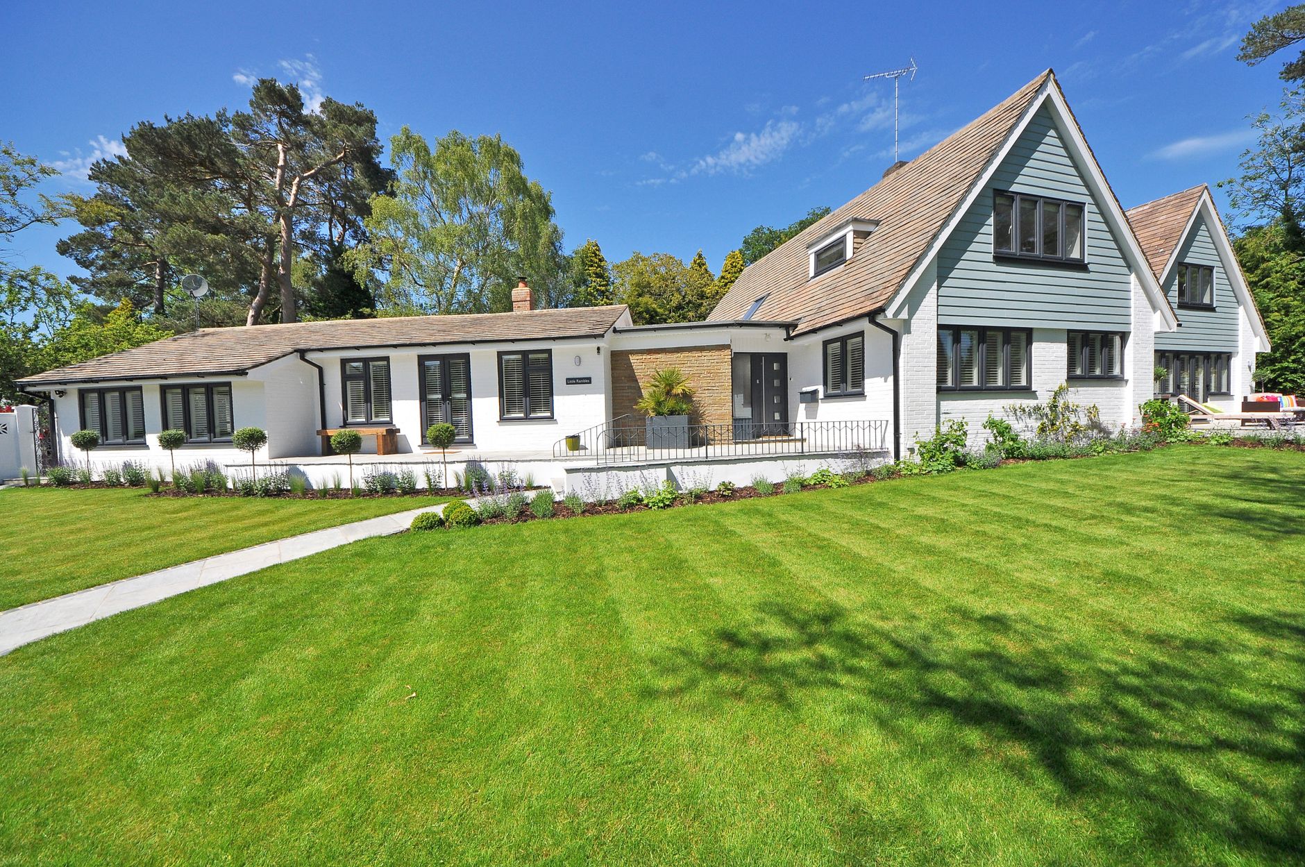 A home with a lush, freshly landscaped green lawn