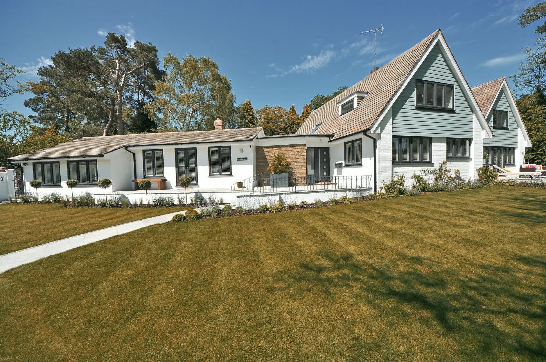The same home with a dry, neglected lawn before landscaping